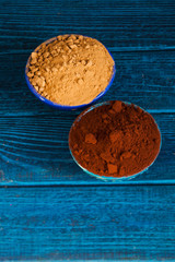 Natural cocoa substitute. Healthy eating concept. Organic carob and cacao powder in bowls.