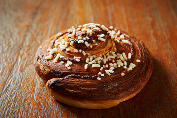 Sweet bread roll on wooden background 