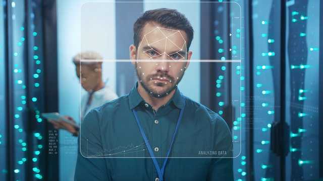 Face ID. Face Detection. Technological Biometric Future Scanning of Face of Caucasian IT Specialist Working in Data Center. 3D Looped Face Animation with Dots and Trackers. Cyber Security and Personal