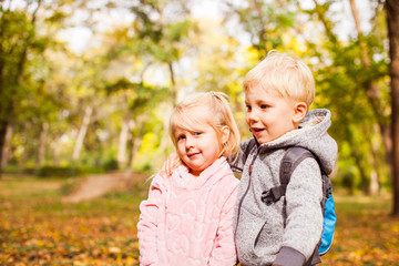 Fototapeta na wymiar Children on a walk in autumn park
