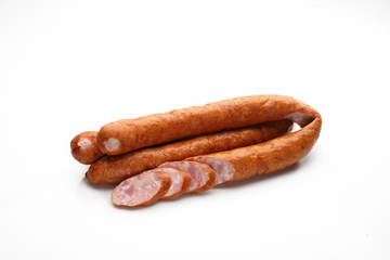 Rings of smoked pork sausage isolated on a white background.