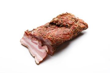 Smoked bacon in herbs in one piece and cut into slices. Isolated on a white background.