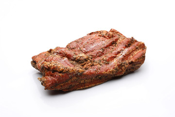 Smoked bacon in herbs in one piece. Isolated on a white background.