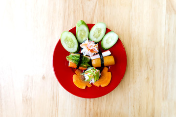 Rice Sushi is a lump of meat on red plate put on wood table  and eaten with sauce in Japanese food restaurant is a popular dish in Thailand  