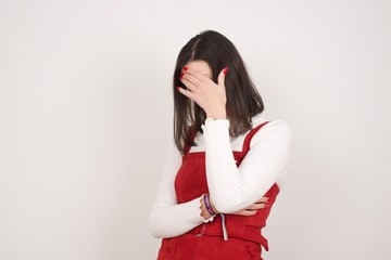 Indoor portrait of beautiful woman with stylish haircut, wearing casual clothes, making facepalm...