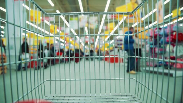 Close up cart in supermarket shopping trolley store buyer shopper purchase market hypermarket time lapse