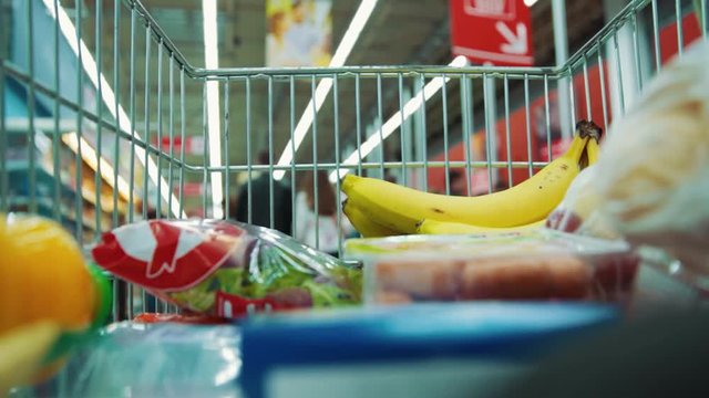 Time lapse cart in supermarket food product lifestyle concept trade shopping trolley store buyer shopper purchase market hypermarket