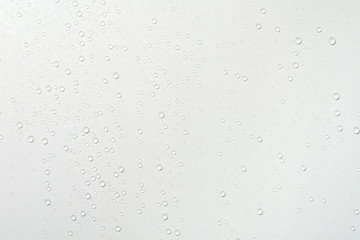 Water drops on white surface background.