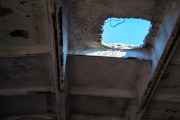 Fototapeta na wymiar Hole in an old concrete ceiling