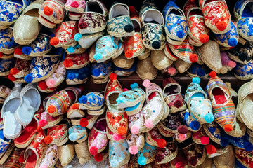 A lot of colorful shoes on the market. View of shoes on the market.