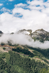 Fog and clouds over the mountains. Beautiful view of the clouds over the mountains