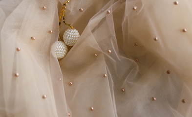 beige material with white beads