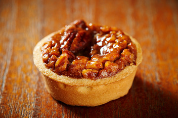 Pecan nuts tart on wooden background 