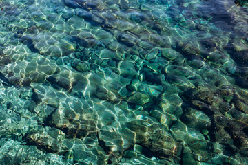 Background of turquoise water in the sea. Turquoise water texture with highlights.