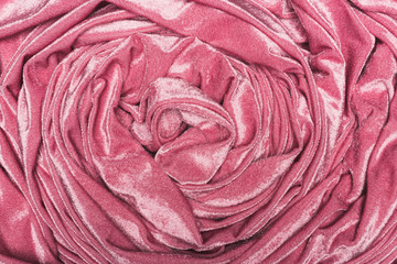 Top view of background of twisted pink velvet cloth