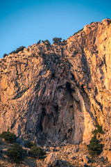 Fototapeta na wymiar Seascape of Corinth canal brown limestone cliffs laminated texture, water reflection bottom view