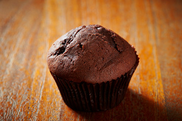 Chocolate cupcake on wooden background 