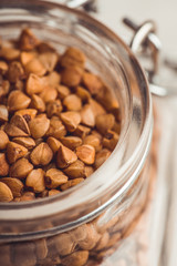 Raw buckwheat on the kitchen table. Selective focus. shallow depth of field.