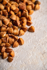 Raw buckwheat on the kitchen table. Selective focus. shallow depth of field.