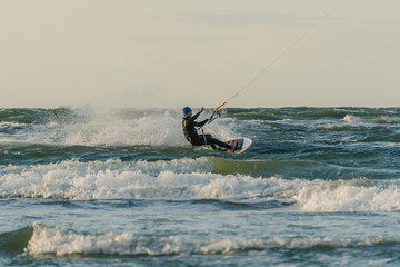 Wave kitesurfer riding waves of the baltic sea