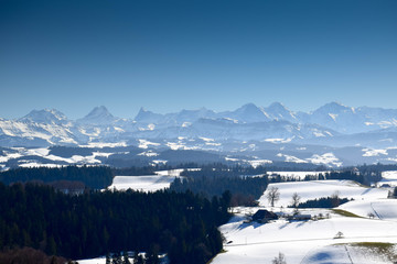 View over the emmental valley ant he alps on a sunny winter day. Canton Bern, Switzerland