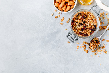 Healthy breakfast Granola with almond and honey on gray stone background