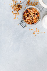 Healthy breakfast Granola with milk or yogurt on gray stone background