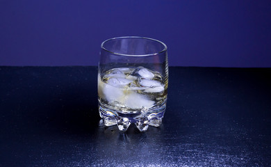 Glass of whiskey with ice cubes isolated on white background.