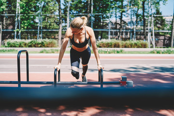 Sporty woman doing physical exercise in fresh air