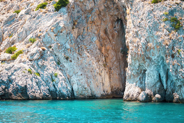 Seascape view to turquoise waters of Aegean Sea in Island Moni near Athens, blue caves. © IrynaV