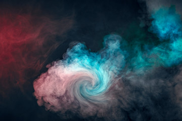 Backlit colorful smoke texture in red blue on a black background.