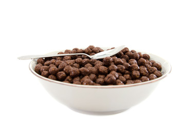 dry breakfast in a plate on a white background. Chocolate balls.