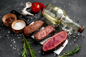 Three  pieces of meat grilled over a meat knife Three types of frying meat, rare, medium, well done. on stone background with copy space for your text