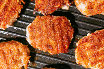 fried cutlets on a griddle grill close up