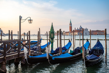 Obraz na płótnie Canvas Gondolas of Venice Italy in the morning against the backdrop of sunrise