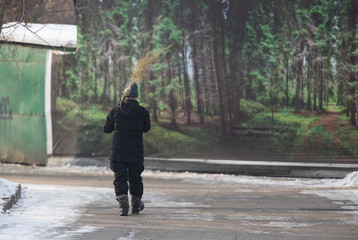 janitor with a broom in the park