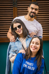 three happy friends are being relaxed and smiley posing for a group photo. Photoshoot with family...