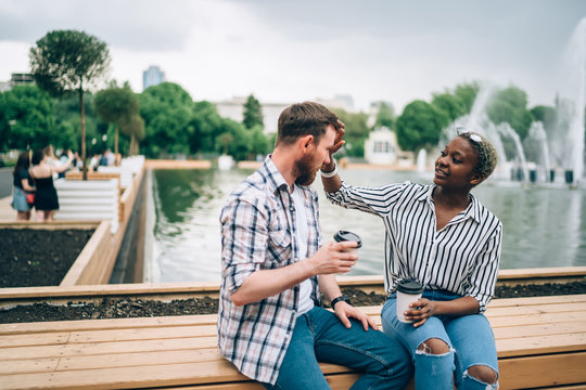 Couple sitting in park and enjoying coffee