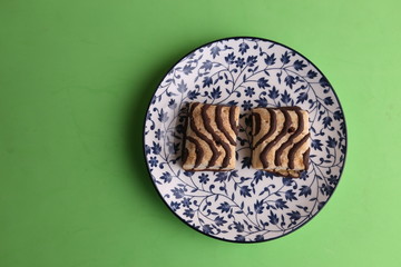 small chocolate cakes in color background