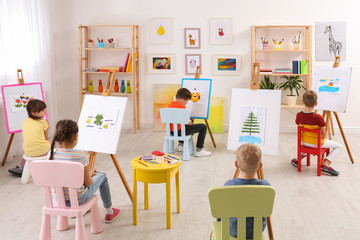 Little children painting during lesson in room