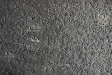 Black painted concrete texture with gray strokes