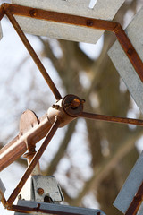 silver metal windmill with rust