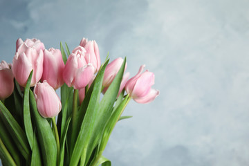 Beautiful pink spring tulips on light blue background, closeup. Space for text