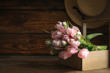 Beautiful bouquet of spring pink tulips on wooden table. Space for text