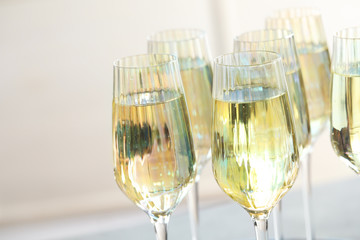 Glasses of champagne on blurred background, closeup view