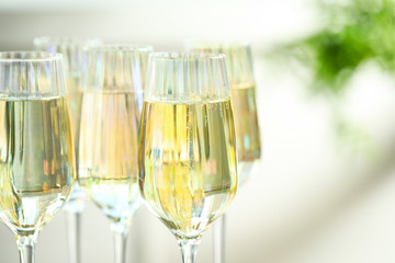 Glasses of champagne on blurred background, closeup view