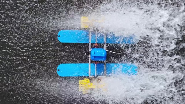 Mini watermill from above on a pond in Sovata. Water splashing. Overhead