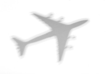 Shadow of an airplane on a white background © uladzimirzuyeu