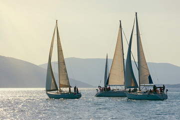 Fototapeta premium Sailing boats on water, regatta, silhouettes. Montenegro, Adriatic Sea, view of Bay of Kotor