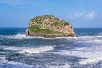 Aquech isle next to Gaztelugatxe, small isle with famous San Juan hermitage located on Bay of Biscay of the northeast Atlantic Ocean in Spain